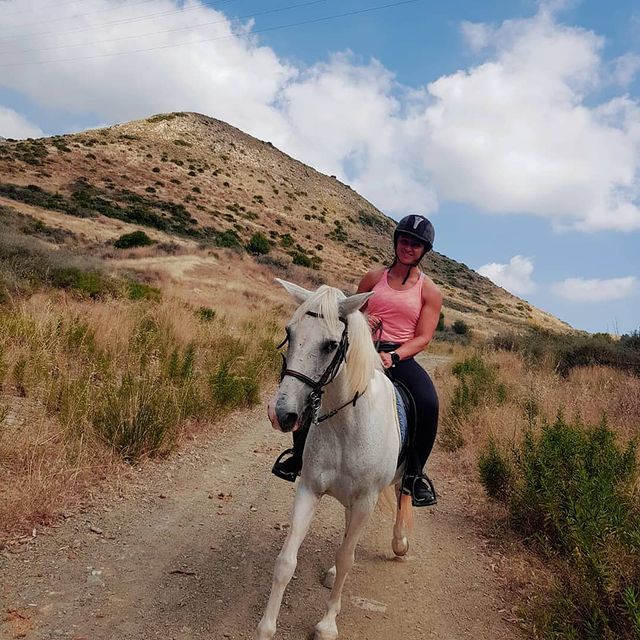 Image shows Kasha riding a horse